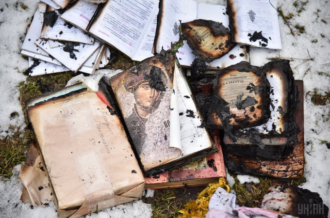 Journalists take pictures of the burnt UOC temple in Lvov