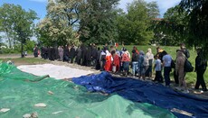 Believers hold a cross procession on the ruins of Tithe Monastery