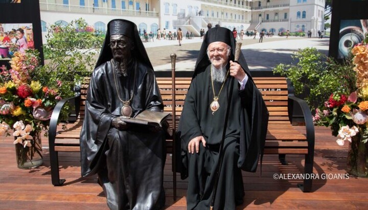 Patriarch Bartholomew sitting next to the monument in his honor. Photo: orthodoxianewsagency