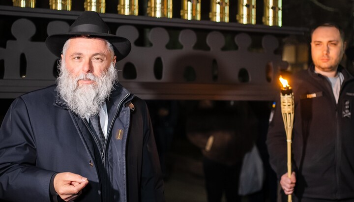 Kyrylo Budanov (right) holding the torch to light the menorah. Photo: JCC BEIT Menachem KYIV Facebook